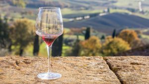 red wine glass on wall with scenery in the background